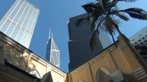 Low Angle Shot Of Towering Buildings Against A Clear Sky.