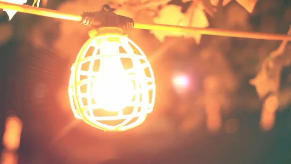 A Close-Up Of A Glowing Light Bulb Creating A Warm Ambiance At Night.